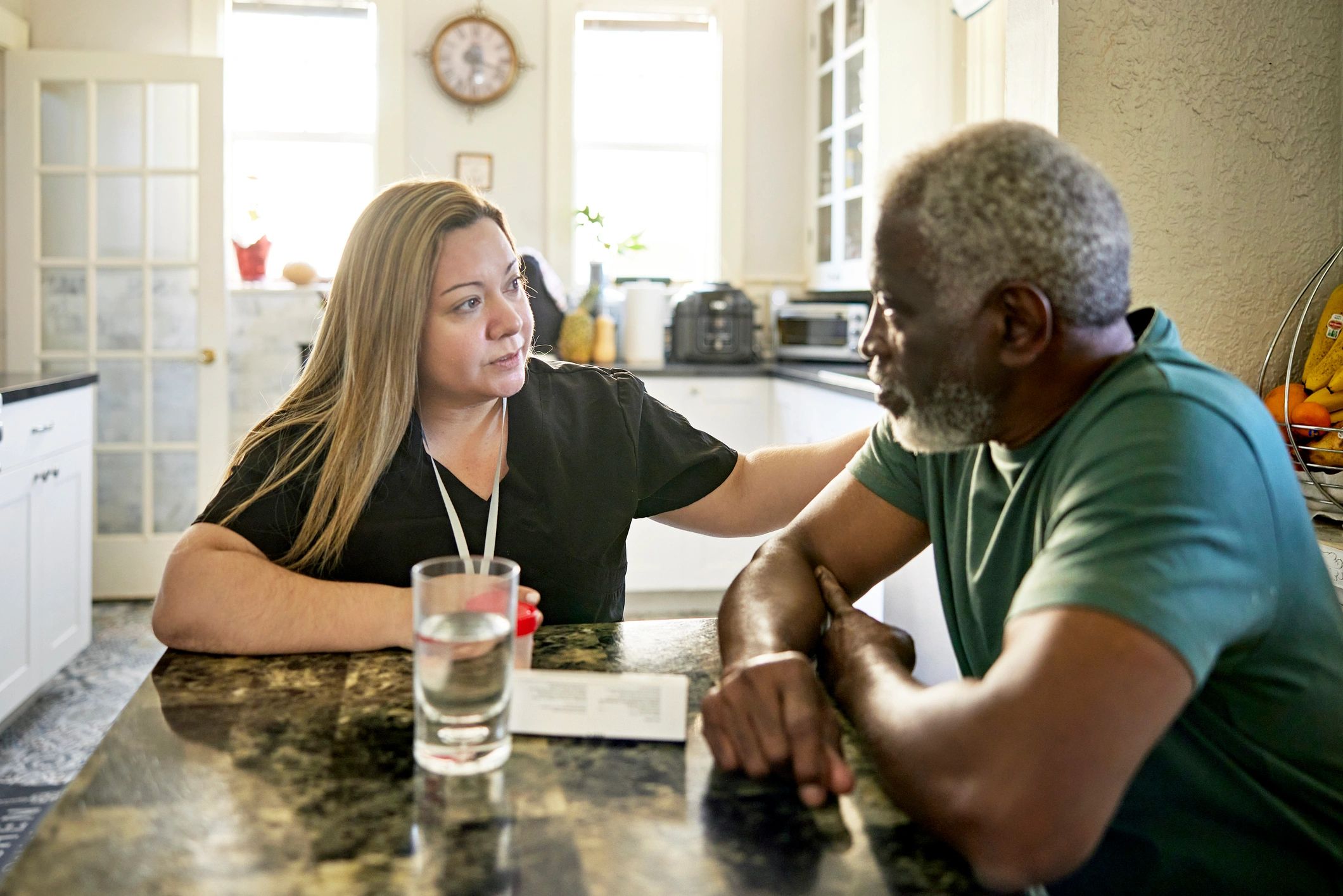 Caregiver speaking with an adult client at home