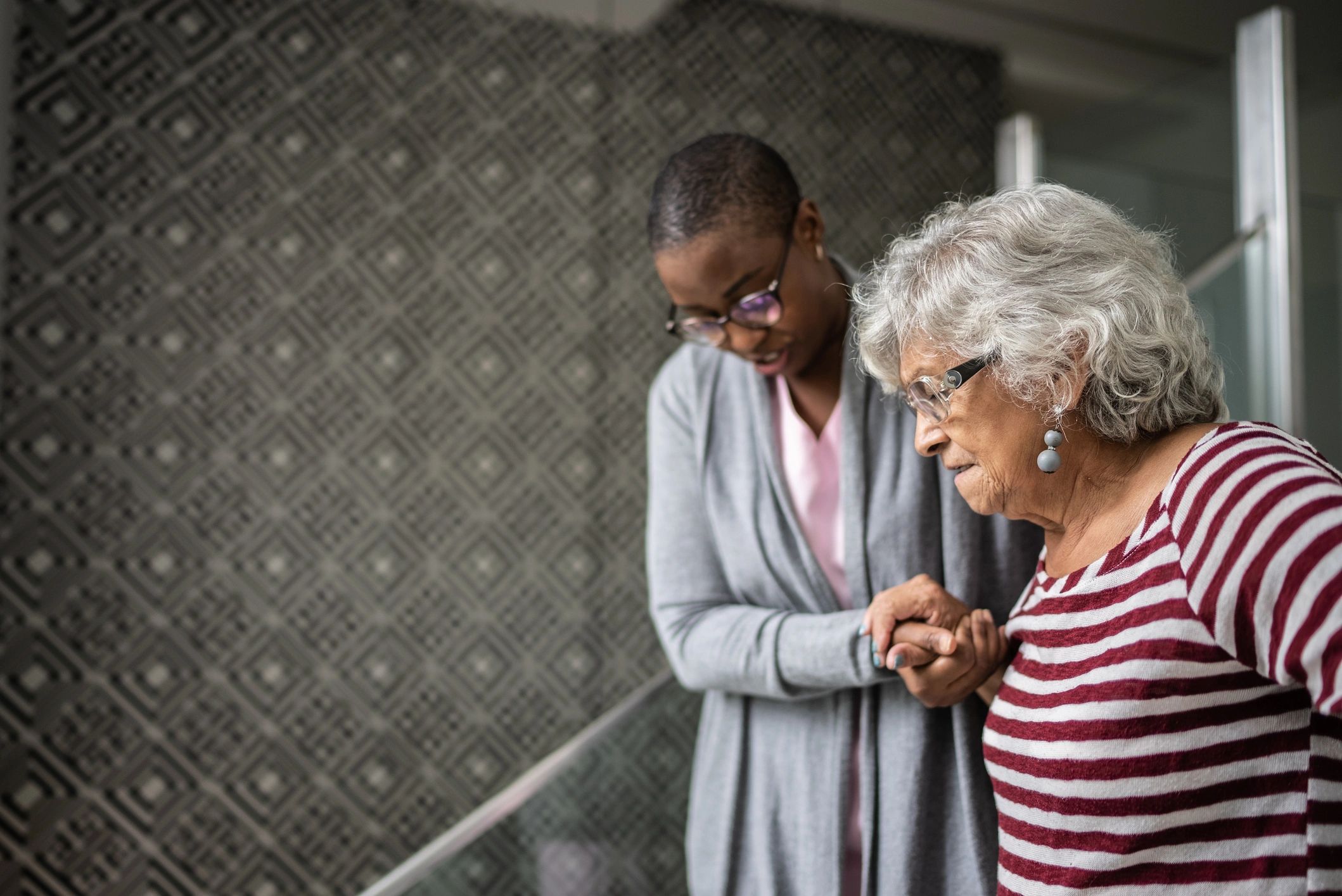 Caregiver supporting an adult with mobility assistance