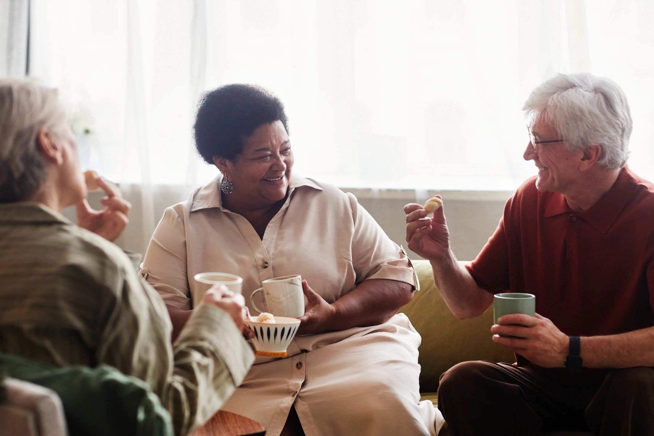 Adults enjoying conversation together in a comfortable home setting