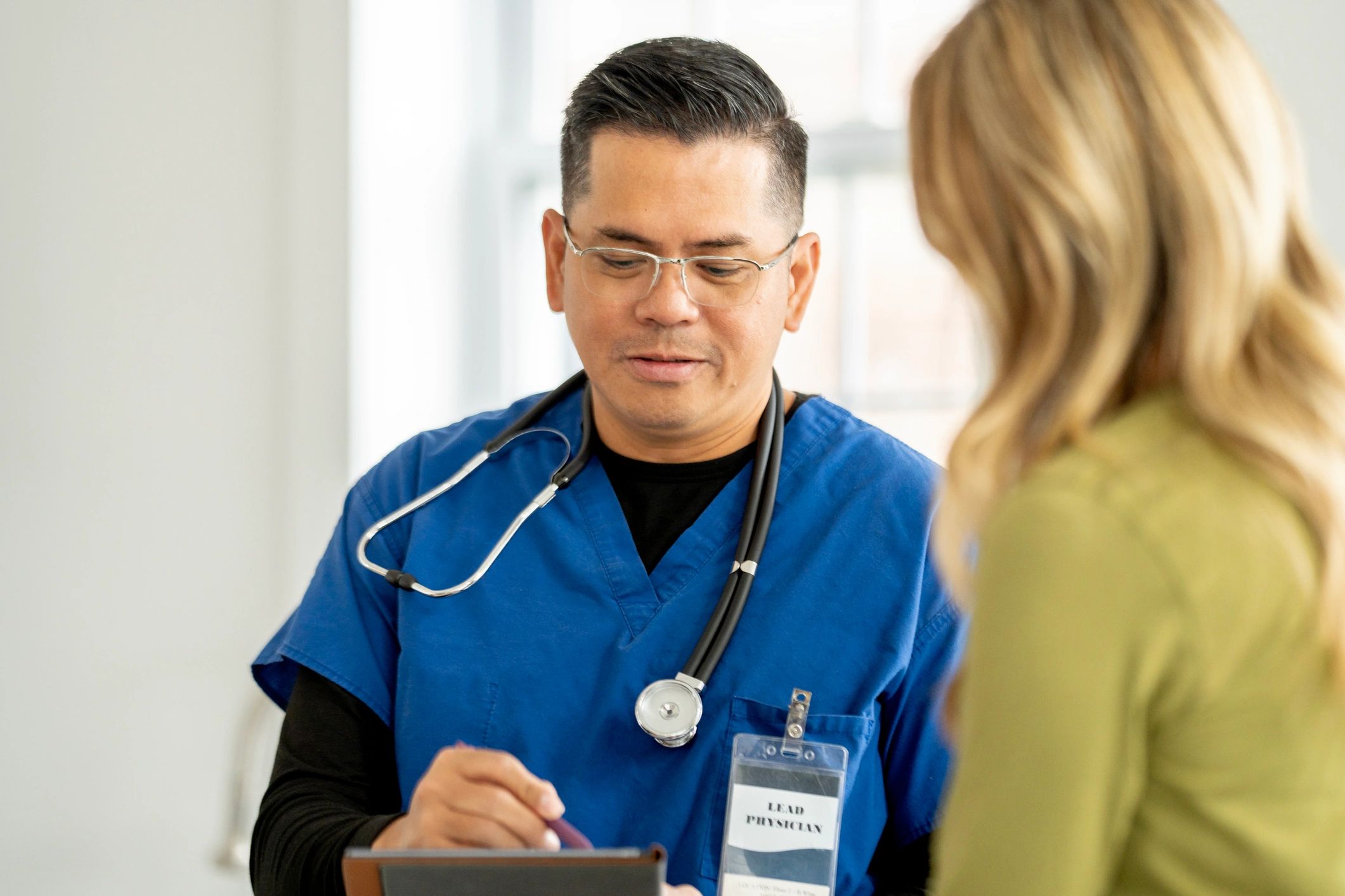 Healthcare professional consulting with an adult patient
